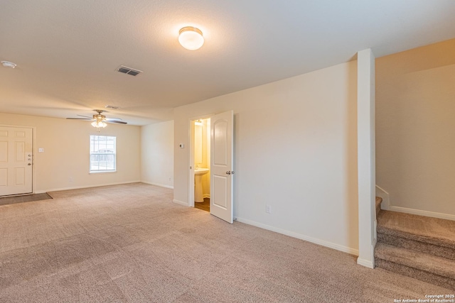 carpeted empty room featuring ceiling fan