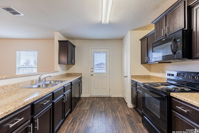 kitchen featuring dark hardwood / wood-style floors, sink, dark brown cabinets, and black appliances