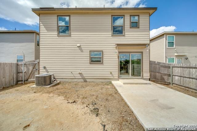 rear view of property featuring central AC unit and a patio area