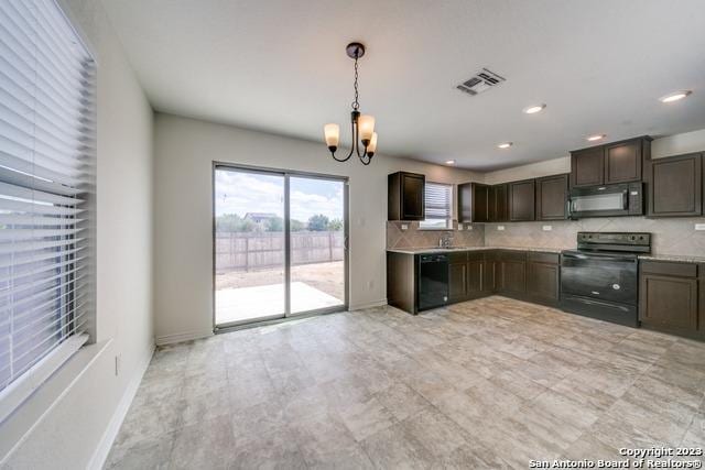 kitchen featuring tasteful backsplash, dark brown cabinetry, black appliances, decorative light fixtures, and a chandelier