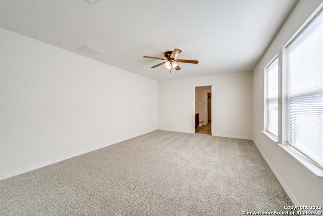 empty room with light carpet and ceiling fan