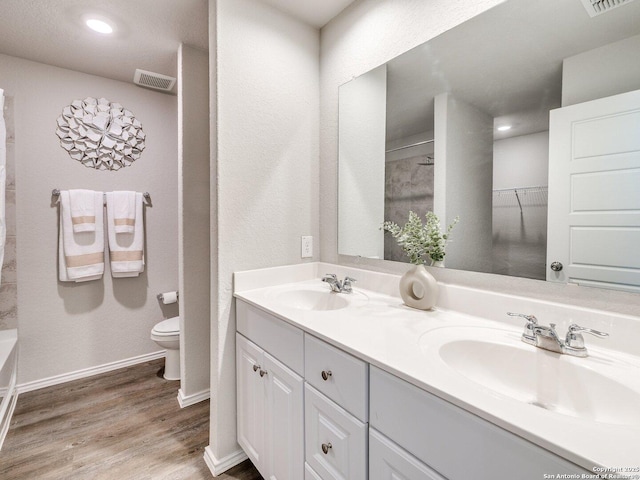 bathroom featuring vanity, toilet, and hardwood / wood-style floors