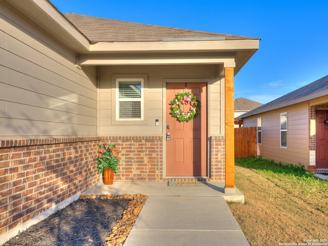 property entrance featuring a lawn