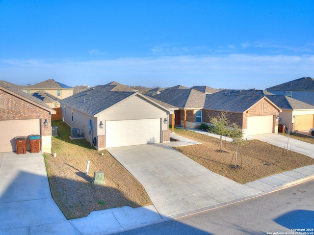 ranch-style house with a garage and central AC unit