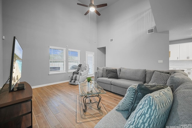 living room with ceiling fan and light wood-type flooring