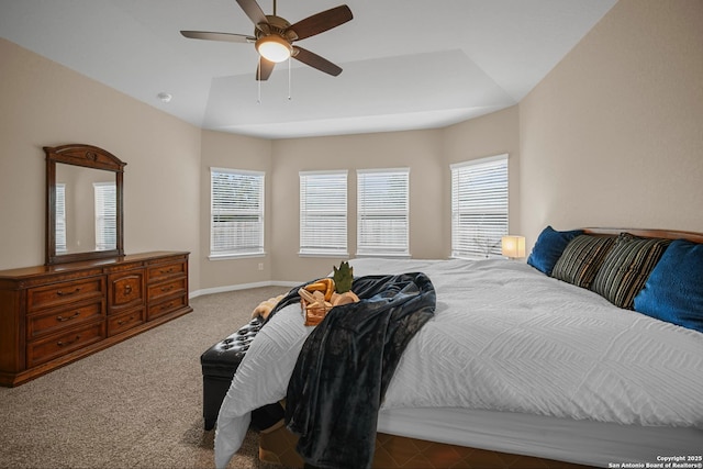 bedroom with lofted ceiling, ceiling fan, and dark colored carpet