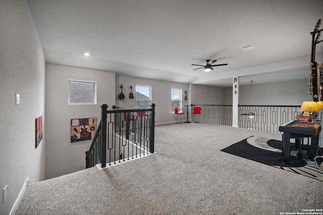 interior space featuring carpet and ceiling fan