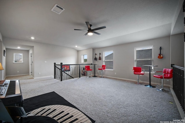 interior space featuring ceiling fan and carpet