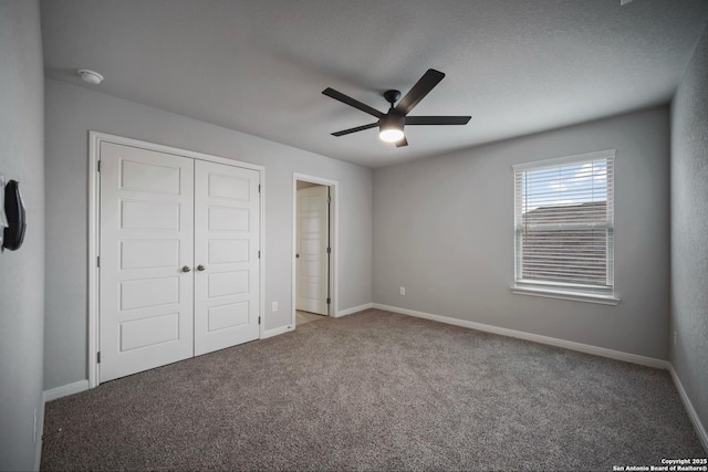 unfurnished bedroom with carpet flooring, ceiling fan, and a closet