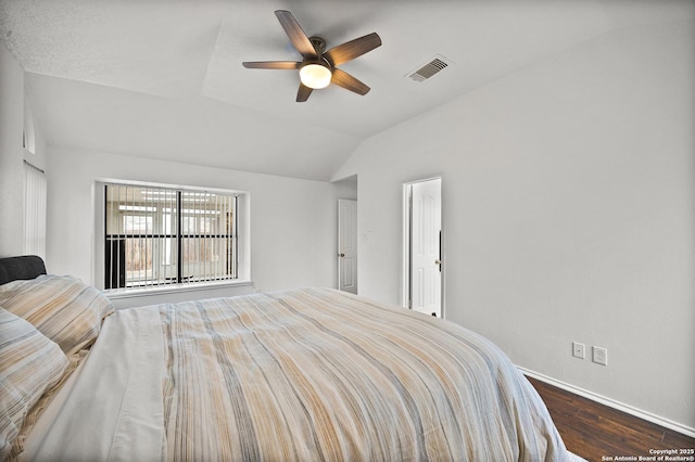 bedroom with dark wood-type flooring, ceiling fan, and lofted ceiling