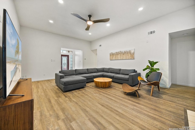 living room with ceiling fan and light wood-type flooring