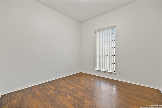 spare room featuring dark hardwood / wood-style floors