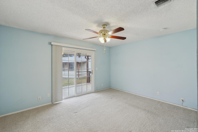 empty room featuring light colored carpet, a textured ceiling, and ceiling fan