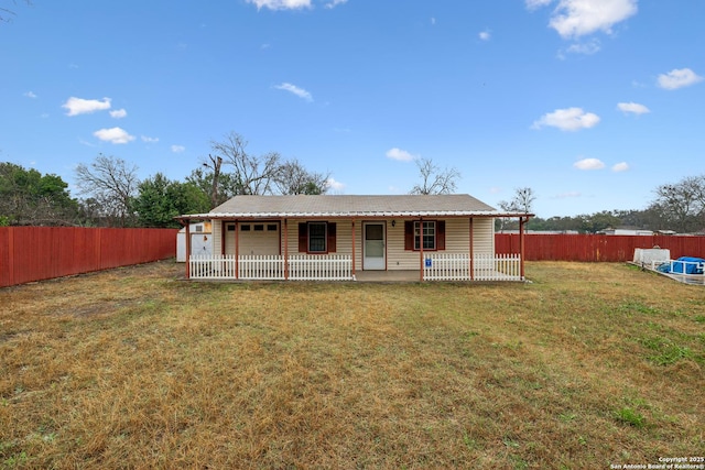 rear view of house with a yard