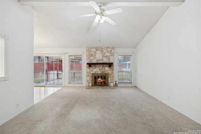 unfurnished living room featuring a stone fireplace, high vaulted ceiling, ceiling fan, and carpet