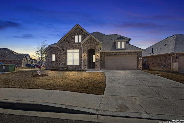 french country inspired facade with a garage