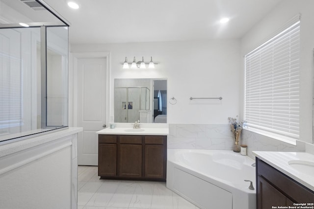 bathroom with plus walk in shower and vanity