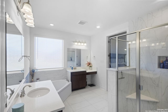 bathroom with vanity and independent shower and bath