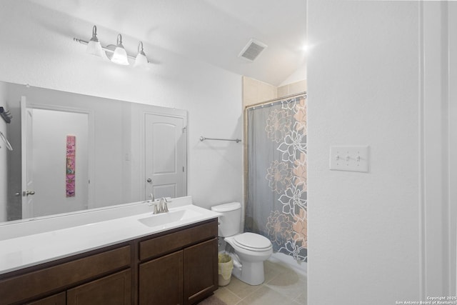 bathroom with vanity, a shower with curtain, vaulted ceiling, tile patterned floors, and toilet