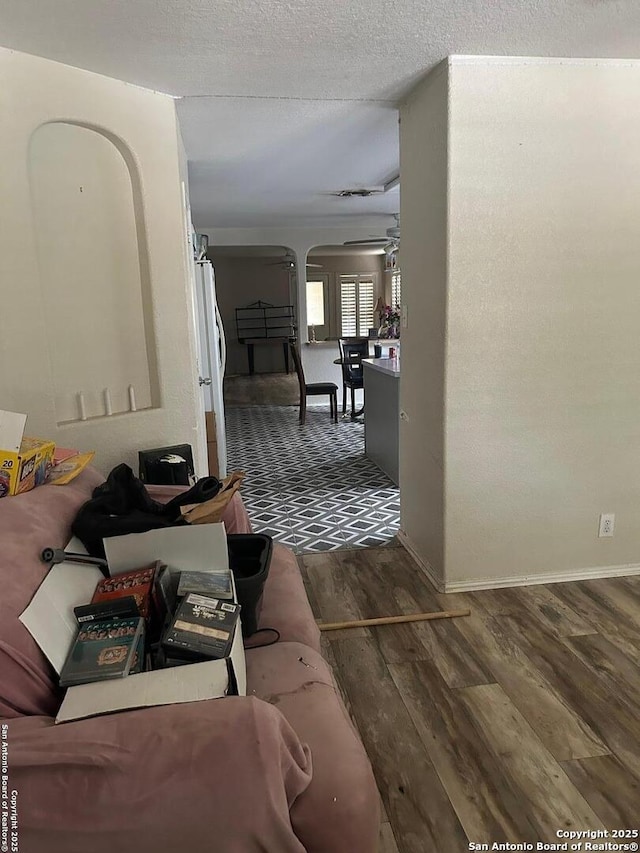 25710 Presidio Aly, Boerne, TX 78015 - hallway with arched walkways, wood finished floors, and a textured ceiling