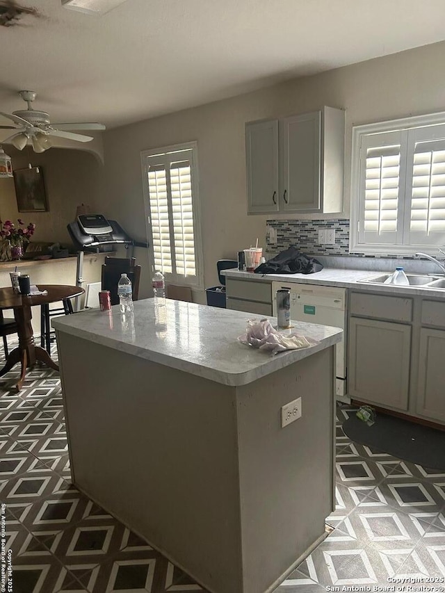 25710 Presidio Aly, Boerne, TX 78015 - kitchen with a sink, a ceiling fan, dark floors, light countertops, and a kitchen island