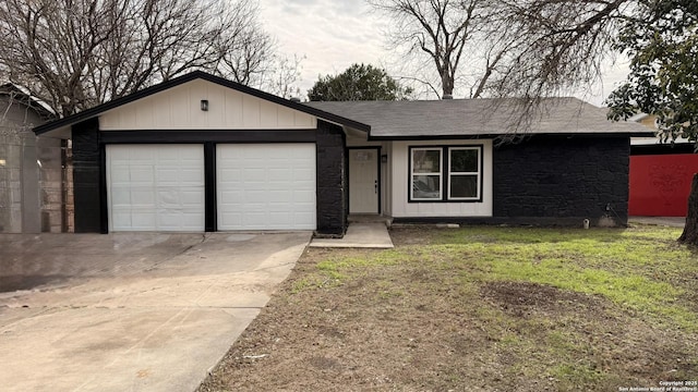 ranch-style house featuring a garage and a front yard