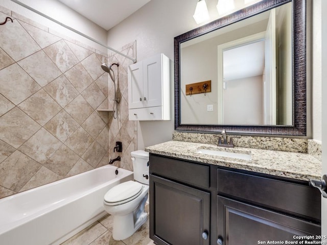 full bathroom featuring tile patterned floors, vanity, toilet, and tiled shower / bath combo