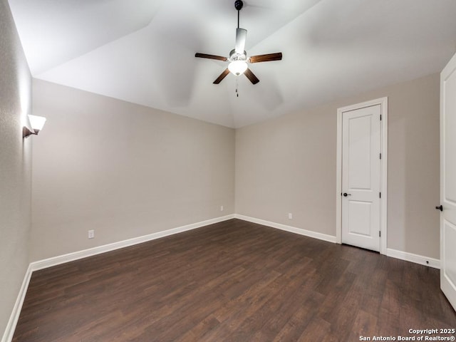 unfurnished room featuring lofted ceiling, dark hardwood / wood-style floors, and ceiling fan