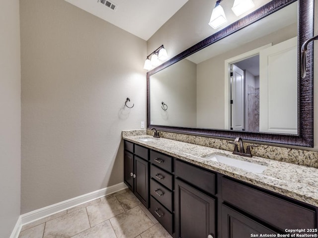 bathroom featuring tile patterned flooring and vanity