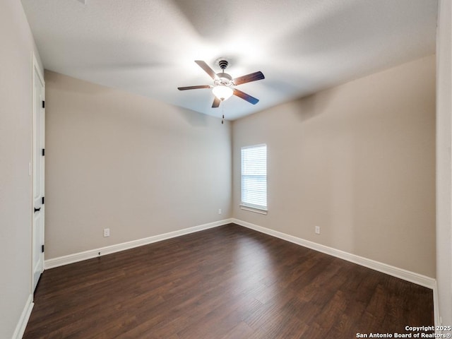 empty room featuring ceiling fan and dark hardwood / wood-style floors