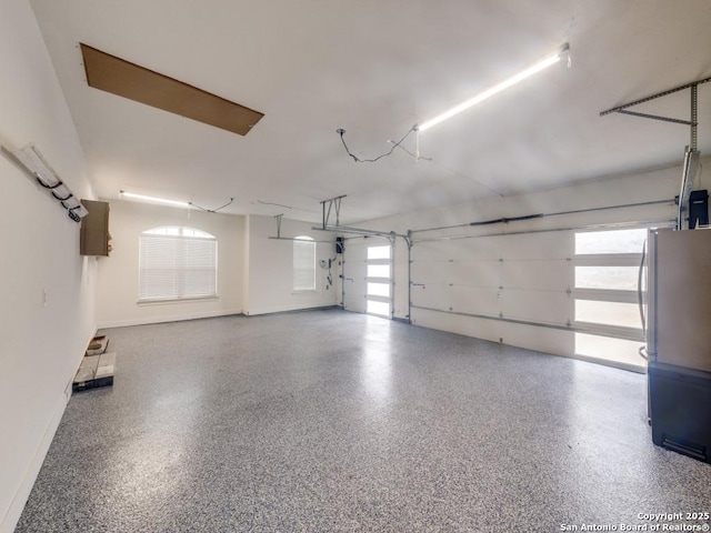 garage with stainless steel refrigerator