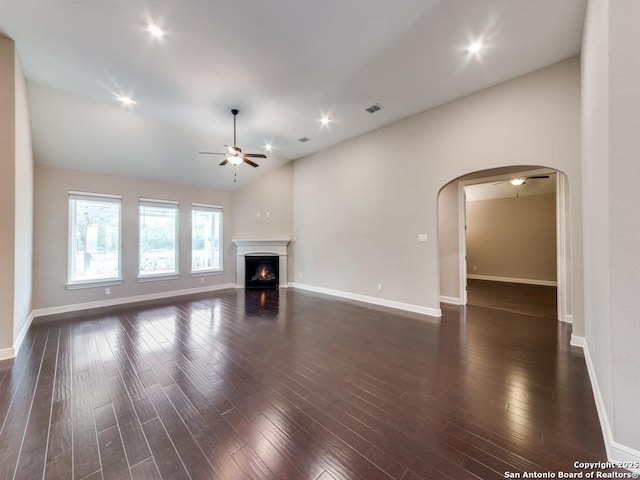 unfurnished living room featuring ceiling fan, lofted ceiling, and dark hardwood / wood-style flooring