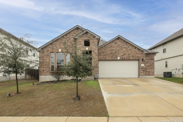 view of front of house with a garage, a front yard, and central air condition unit