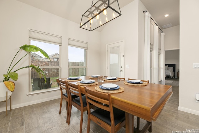 dining space featuring hardwood / wood-style flooring and a notable chandelier