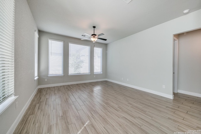 unfurnished room with ceiling fan and light wood-type flooring