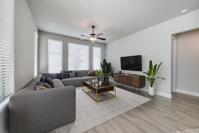 living room with ceiling fan and light hardwood / wood-style floors