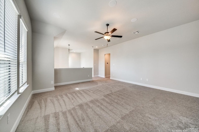 empty room with light colored carpet and ceiling fan