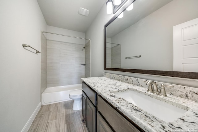 full bathroom featuring vanity, toilet, and tiled shower / bath