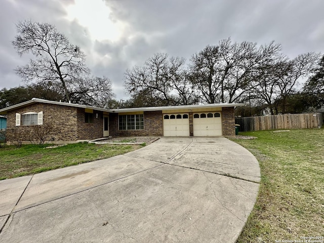 ranch-style house featuring a garage and a front yard