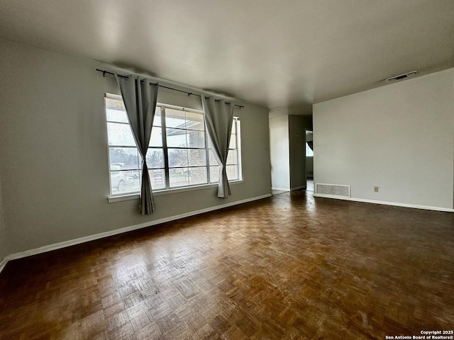 empty room with dark parquet flooring