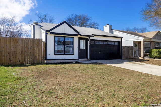 view of front of property featuring a garage and a front lawn