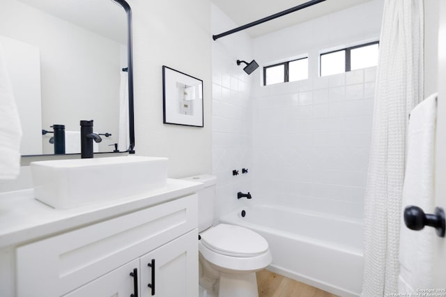 full bathroom with hardwood / wood-style flooring, vanity, toilet, and shower / bath combo