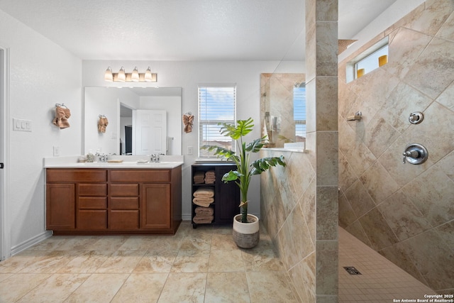 bathroom featuring vanity and a tile shower