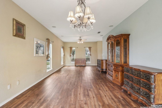 unfurnished living room with dark hardwood / wood-style floors and ceiling fan with notable chandelier