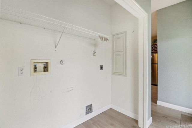 washroom with hardwood / wood-style flooring, gas dryer hookup, washer hookup, and hookup for an electric dryer