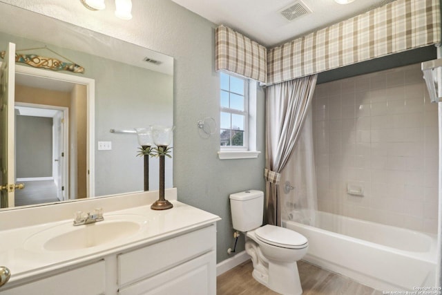 full bathroom with shower / tub combo, vanity, hardwood / wood-style flooring, and toilet