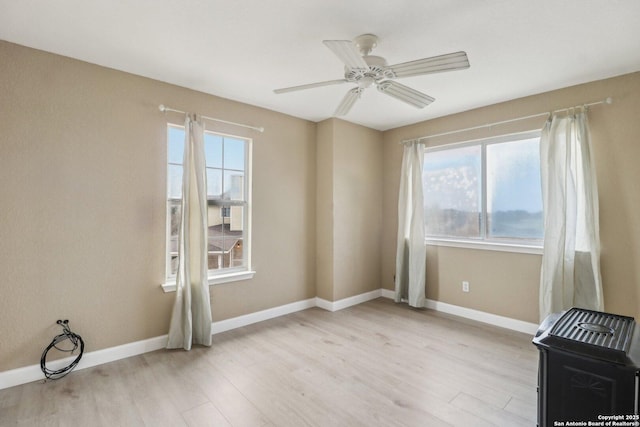 unfurnished room featuring light hardwood / wood-style flooring and ceiling fan