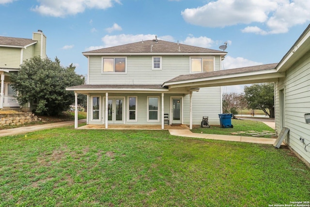 rear view of property featuring a yard