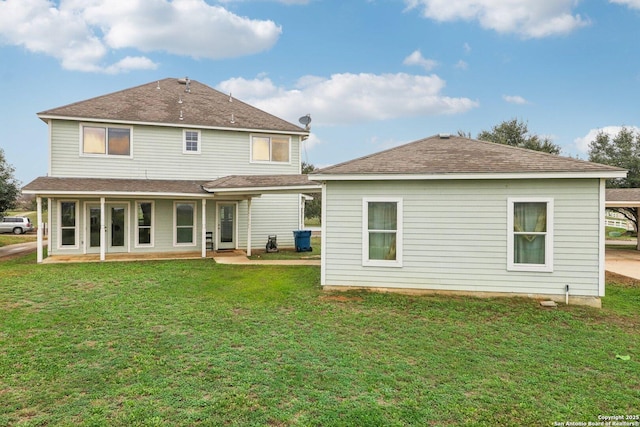 back of house with a lawn