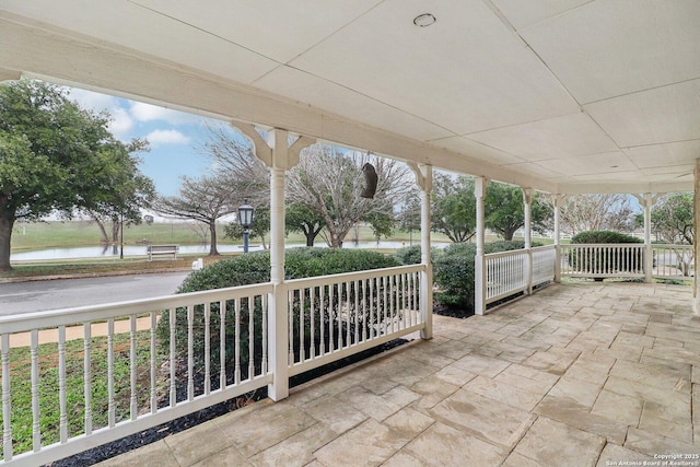 view of patio with a water view